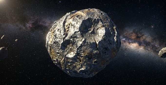 Ilustração artística do asteroide Psyche, um corpo metálico no cinturão principal, com crateras visíveis, representando seu potencial como núcleo de um planeta perdido.