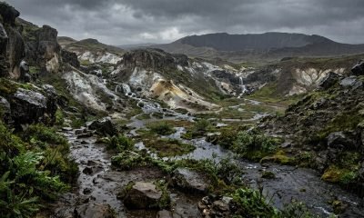 Ilustração de chuvas tropicais em Marte, com água caindo sobre rochas de caulim na cratera Jezero, indicando um passado úmido e chuvoso.